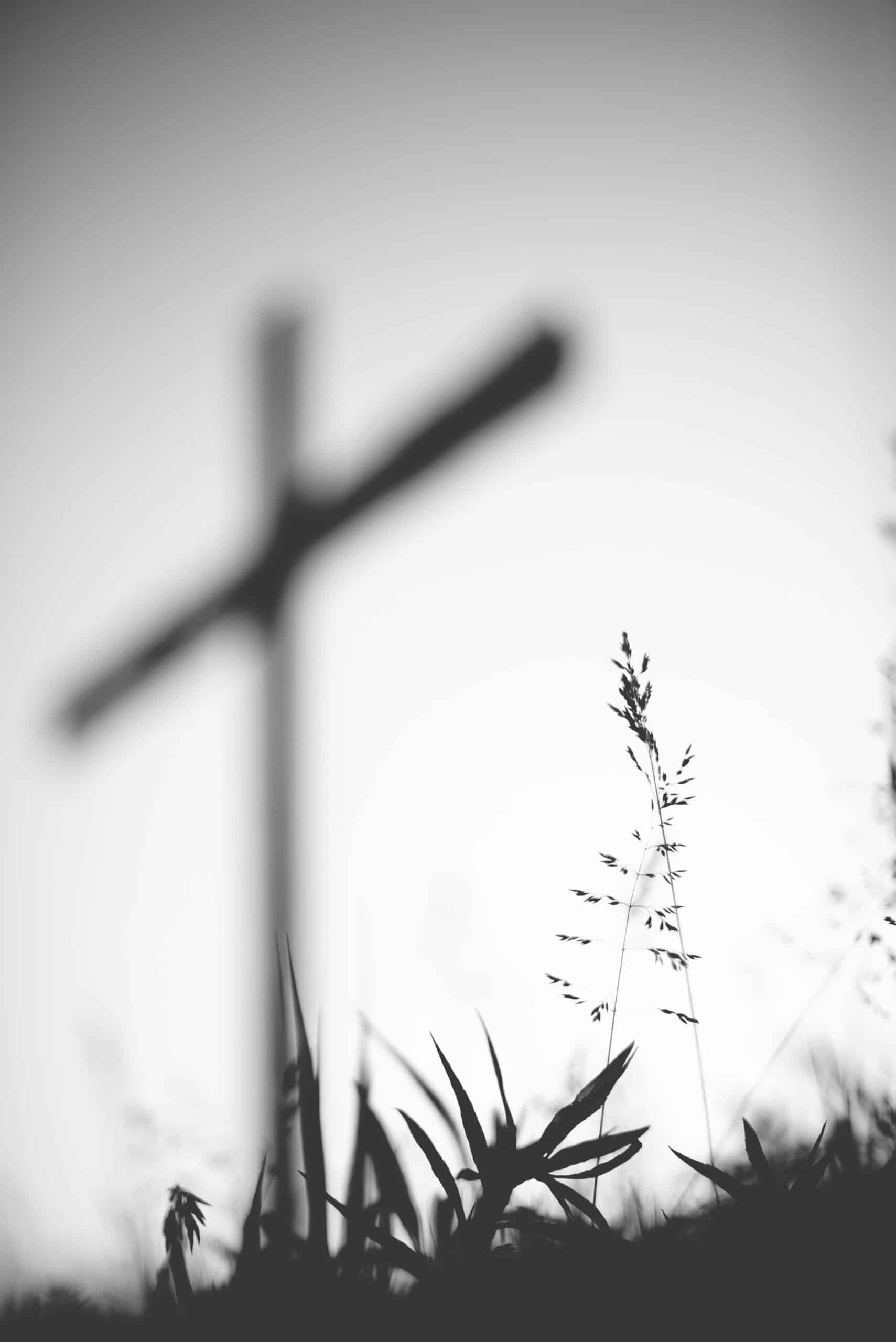 Grayscale landscape with a Cross in the background.